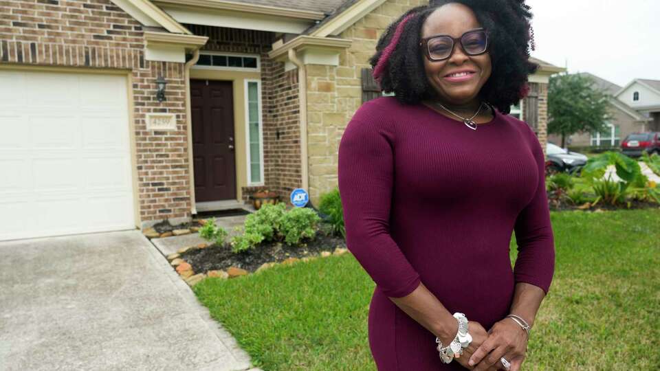 LaKeisha Lott talks about the her journey to homeownership at her home, Saturday, Dec. 2, 2023, in Humble. Lott was able to purchase her home in 2020 with the help of the Housing Choice Voucher program from the Texas Department of Housing and Community Affairs.