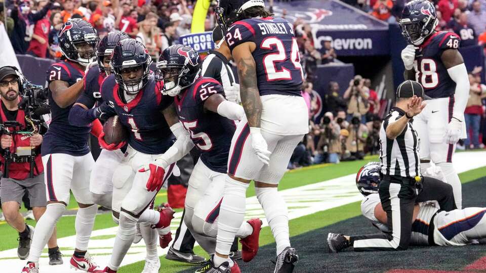 Houston Texans safety Jimmie Ward (1) celebrates with his teammates after intercepting a pass in the end zone intended for Denver Broncos tight end Lucas Krull (85) with 16 seconds left in the fourth quarter of an NFL football game Sunday, Dec. 3, 2023, in Houston. The interception ended the Broncos scoring threat. The Texans took a knee on the next play ending the game.