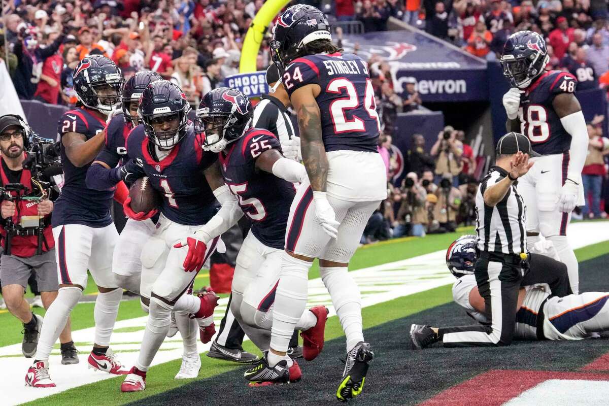 Houston Texans safety Jimmie Ward (1) celebrates with his teammates after intercepting a pass in the end zone intended for Denver Broncos tight end Lucas Krull (85) with 16 seconds left in the fourth quarter of an NFL football game Sunday, Dec. 3, 2023, in Houston. The interception ended the Broncos scoring threat. The Texans took a knee on the next play ending the game.