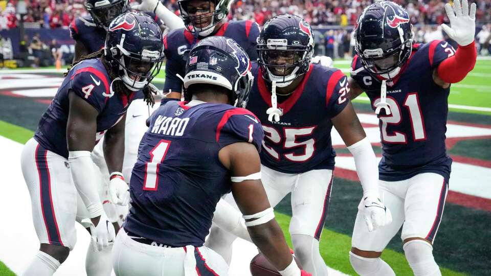 Houston Texans safety Jimmie Ward (1) celebrates with his teammates after intercepting a pass in the end zone intended for Denver Broncos tight end Lucas Krull with 16 seconds left in the fourth quarter of an NFL football game Sunday, Dec. 3, 2023, in Houston. The interception ended the Broncos scoring threat. The Texans took a knee on the next play ending the game.