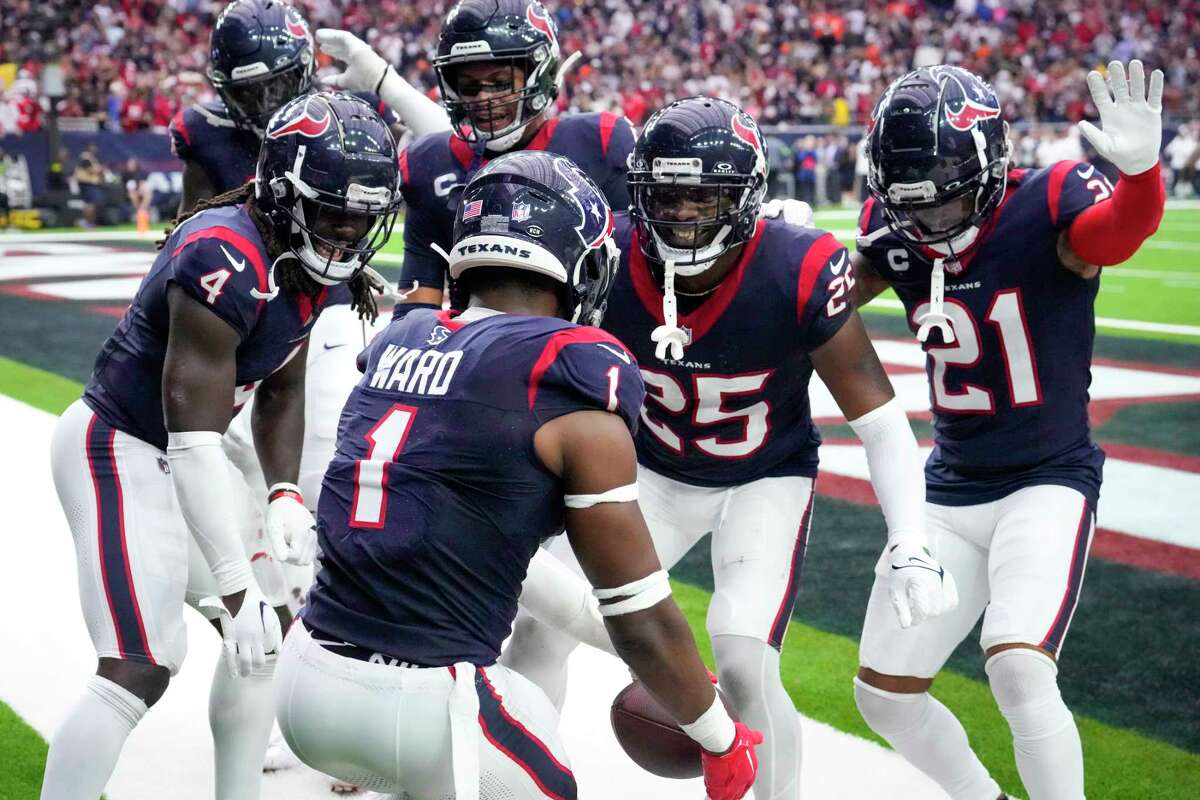 Houston Texans safety Jimmie Ward (1) celebrates with his teammates after intercepting a pass in the end zone intended for Denver Broncos tight end Lucas Krull with 16 seconds left in the fourth quarter of an NFL football game Sunday, Dec. 3, 2023, in Houston. The interception ended the Broncos scoring threat. The Texans took a knee on the next play ending the game.