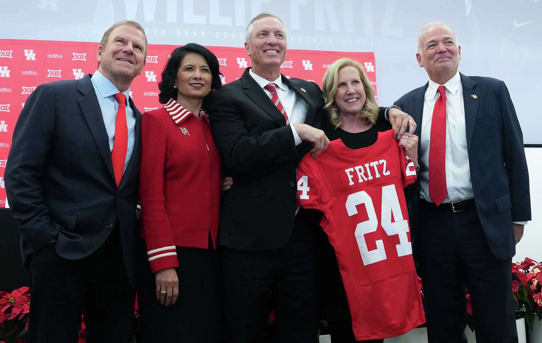 University of Houston head football coach Willie Fritz and his wife Susan, poses with a jersey along with (from left) Tilman Fertitta, Chairman UH System Board of Regents, UH President Renu Khator, and Chris Pezman, VP for UH Athletics, on following his official press conference on Monday, Dec. 4, 2023 in Houston.