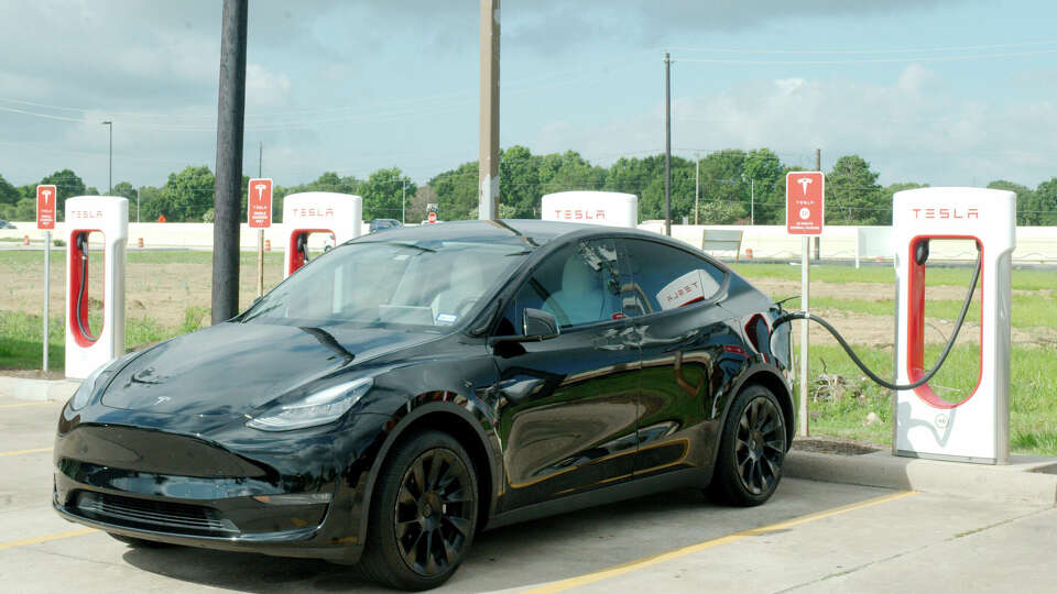 A Tesla vehicle is charged at a Tesla charging station at Rudy's Country Store and Bar-B-Q on I45 Gulf Freeway in Webster Tuesday, June 13, 2023.