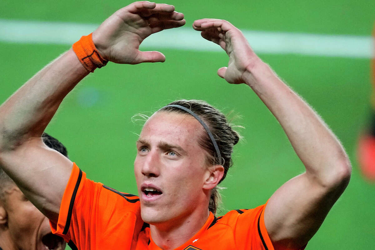 Houston Dynamo midfielder Griffin Dorsey (25) raises his arms getting the fans to cheer during the second half of an MLS Western Conference semifinal soccer match against Sporting Kansas City on Sunday, Nov. 26, 2023 in Houston. The Dynamo advanced to the MLS Western Conference Finals with a 1-0 win.