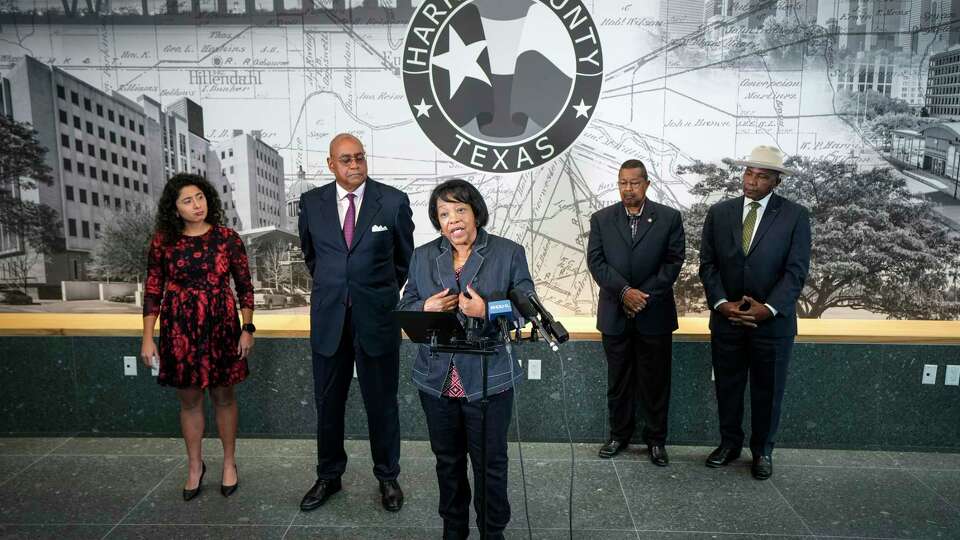 Celeste Bedford Walker, center, with County Judge Lina Hidalgo, from left, County Commissioner Rodney Ellis, Capt. Paul Matthews and Clyde Lemon standing behind her, speaks during a news conference on Tuesday, Dec. 5, 2023 in Houston, where it was announced that Commissioners Court will make a resolution that apologizes to the families of African American soldiers who were killed, beaten, and unjustly convicted during the 1917 Camp Logan Riot. The U.S. Army overturned the convictions of 110 Black soldiers in the Camp Logan Riots that took place in the summer of 1917 and involved the all-Black 3rd Battalion of the 24th Infantry Regiment, which was deployed in Houston to guard the construction of the Camp Logan training site, located in what is today Memorial Park.