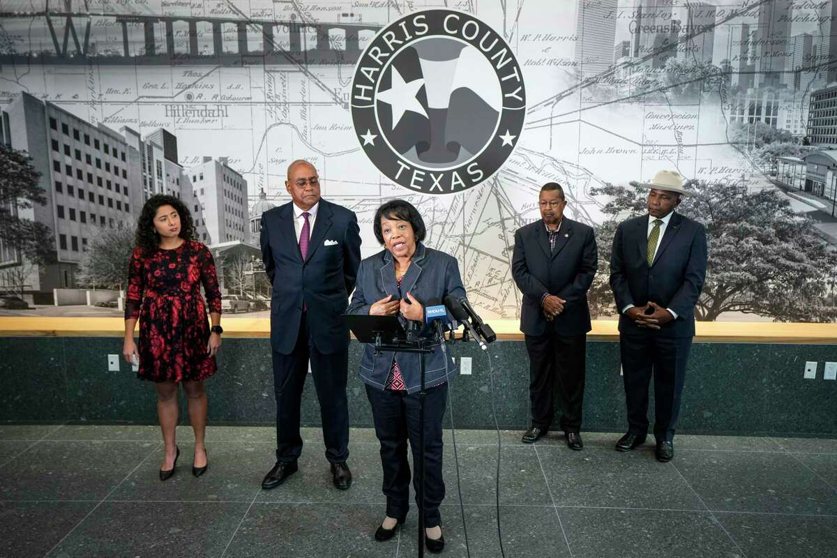 Celeste Bedford Walker, center, with County Judge Lina Hidalgo, from left, County Commissioner Rodney Ellis, Capt. Paul Matthews and Clyde Lemon standing behind her, speaks during a news conference on Tuesday, Dec. 5, 2023 in Houston, where it was announced that Commissioners Court will make a resolution that apologizes to the families of African American soldiers who were killed, beaten, and unjustly convicted during the 1917 Camp Logan Riot. The U.S. Army overturned the convictions of 110 Black soldiers in the Camp Logan Riots that took place in the summer of 1917 and involved the all-Black 3rd Battalion of the 24th Infantry Regiment, which was deployed in Houston to guard the construction of the Camp Logan training site, located in what is today Memorial Park.