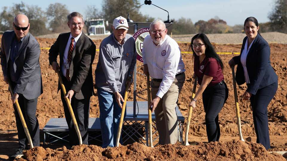 From left are: Dr. Thomas Seaberry, deputy superintendent of school leadership; Principal Steven Speyrer; Commissioner Barry C. Beard; Eddie Conger, superintendent, CEO, founder; Subic Vu, deputy superintendent, Houston; Dr. Laura Carrasco, deputy superintendent of academics and student services.