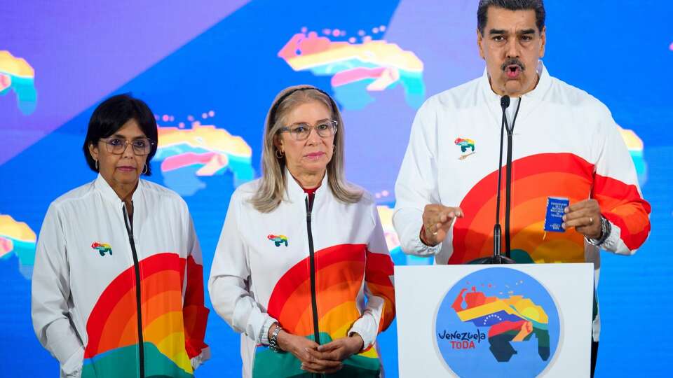 Nicolas Maduro, Venezuela's president, right, speaks to members of the media, next to First Lady Cilia Flores, center, and Delcy Rodriguez, Venezuela's vice president, left, after casting a ballot during a referendum vote in Caracas, Venezuela, on Sunday, Dec. 3, 2023. Following massive offshore oil discoveries in the region by Exxon Mobil Corp. and others, and with elections approaching, President Maduro is inflaming regional tension by reviving a long-dormant border dispute over the area known as the Essequibo. Photographer: Gaby Oraa/Bloomberg