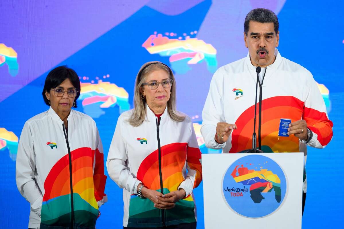 Nicolas Maduro, Venezuela's president, right, speaks to members of the media, next to First Lady Cilia Flores, center, and Delcy Rodriguez, Venezuela's vice president, left, after casting a ballot during a referendum vote in Caracas, Venezuela, on Sunday, Dec. 3, 2023. Following massive offshore oil discoveries in the region by Exxon Mobil Corp. and others, and with elections approaching, President Maduro is inflaming regional tension by reviving a long-dormant border dispute over the area known as the Essequibo. Photographer: Gaby Oraa/Bloomberg