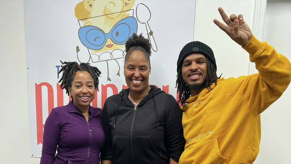 TikTok food critic Keith Lee (right) and his wife Ronnie Lee (left) visited The Puddery on Nov. 28 after trying its signature banana pudding and other dessert iterms. Owner Janel Prator (center) received a $2,000 tip from Lee following the review.