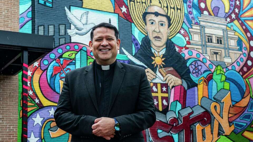 University of St. Thomas Director of the Center Semillero, Fr. Dempsey Rosales-Acosta, stands in front of a contemporary mural of recognizing university namesake St. Thomas in the context of the Hispanic community Friday, Dec. 8, 2023 in Houston.