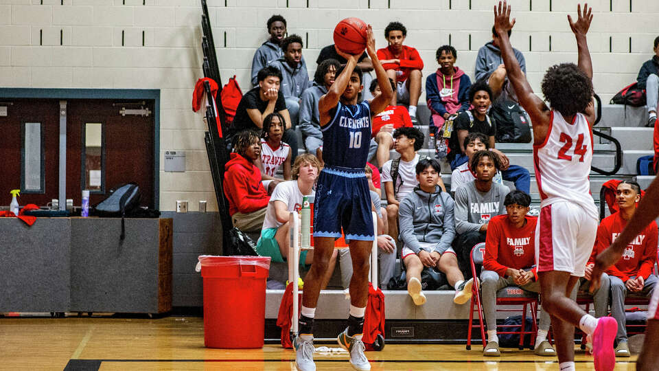 Clements' Keshav Vijaykumar (10) tries to put up a shot against Fort Bend Travis in the first half of a high school boys basketball game Friday, Dec. 8, 2023 at Fort Bend Travis High School.