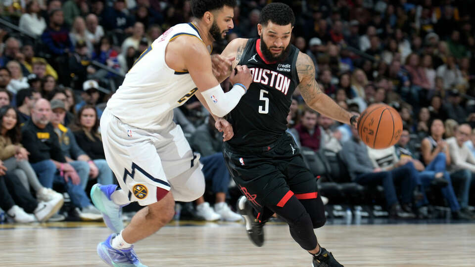 Houston Rockets guard Fred VanVleet, right, drives against Denver Nuggets guard Jamal Murray during the second half of an NBA basketball game Friday, Dec. 8, 2023, in Denver. (AP Photo/David Zalubowski)