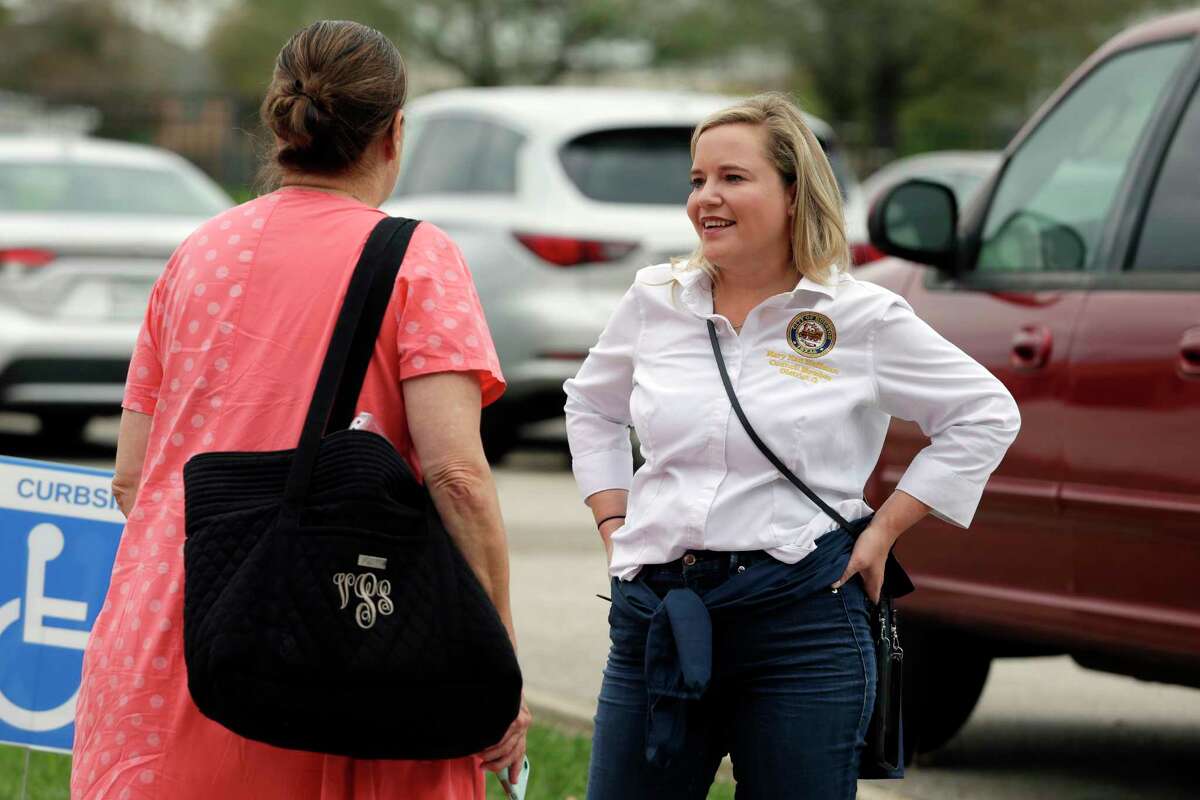 District G city councilor and incumbent candidate Mary Nan Huffman, right, talks with a voter (REFUSED ID) in the parking lot of Paul Revere Middle School Saturday, Dec. 9, 2023 in Houston.