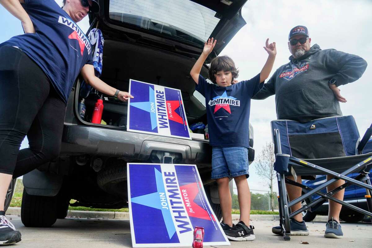 Cooper Soto, 7, reacts after his toy car made it down a pair of political signs used as a ramp alongside his parents, Nickki and Jose, at the Kingwood Park Community Center on Election Day, Saturday, Dec. 9, 2023, in Kingwood. 