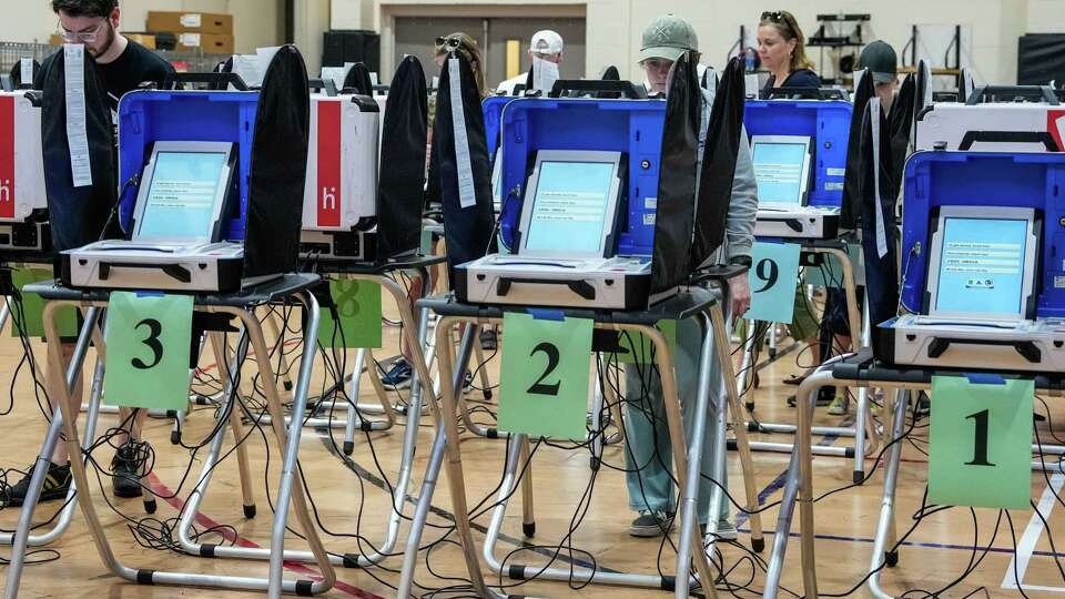 People vote at the West Gray Multi Service Center on Election Day on Saturday, Dec. 9, 2023, in Houston.