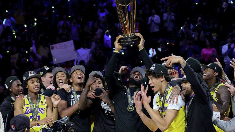 LAS VEGAS, NEVADA - DECEMBER 09: LeBron James #23 of the Los Angeles Lakers hoist the trophy with his teammates after winning the championship game of the inaugural NBA In-Season Tournament at T-Mobile Arena on December 09, 2023 in Las Vegas, Nevada. NOTE TO USER: User expressly acknowledges and agrees that, by downloading and or using this photograph, User is consenting to the terms and conditions of the Getty Images License Agreement.