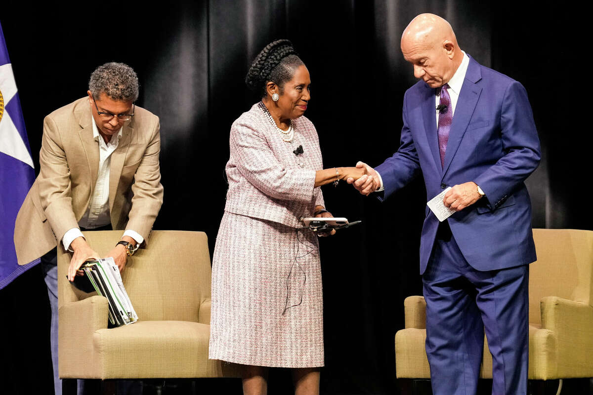 HOUSTON, TEXAS - DECEMBER 4: Houston mayoral candidates Rep. Sheila Jackson Lee, left, and State Sen. John Whitmire shake hands as they arrive on stage for the final mayoral debate at Texas Southern University on Monday, Dec. 4, 2023 in Houston. A runoff election to decide the Houston mayors race is set for Dec. 9. (Brett Coomer/Houston Chronicle via Getty Images)