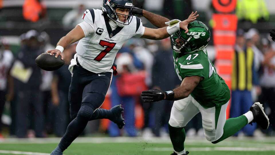 Houston Texans quarterback C.J. Stroud (7) rolls out of the pocket under pressure from New York Jets linebacker Bryce Huff (47) during the first quarter of an NFL football game, Sunday, Dec. 10, 2023, in East Rutherford, N.J. (AP Photo/Adam Hunger)