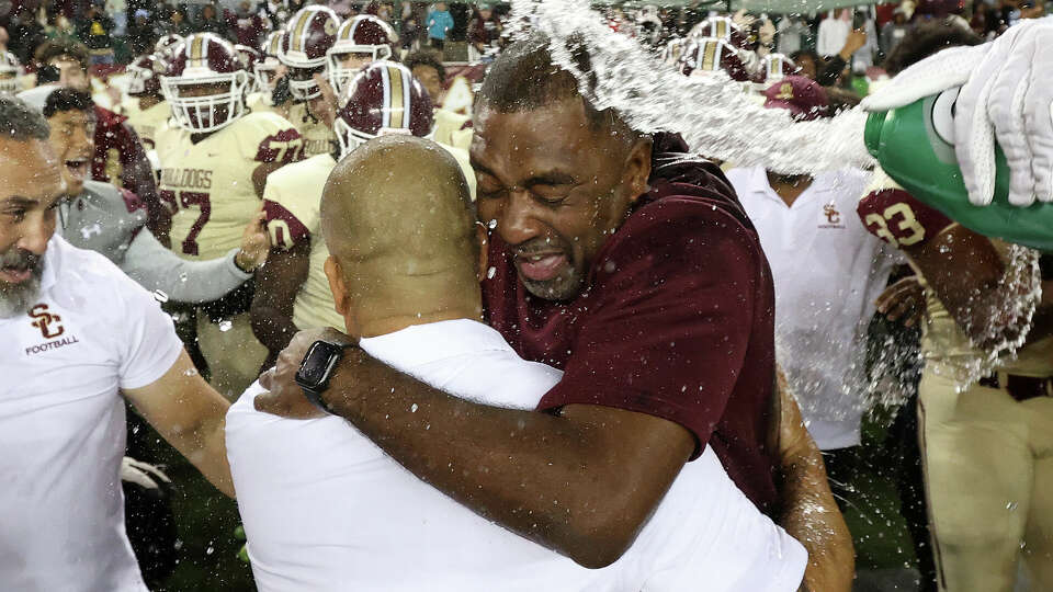 Summer Creek Head Coach Kenny Harrison is doused with water as he celebrates with assistant coaches after defeating Cibolo Steele in a Class 6A Division II state semifinal game Saturday, Dec. 9, 2023, in Waco, Texas.