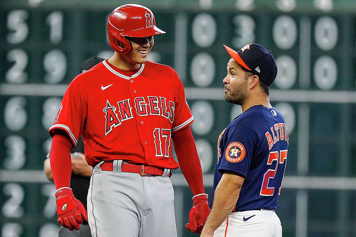 HOUSTON, TEXAS - JULY 03: Jose Altuve #27 of the Houston Astros and Shohei Ohtani #17 of the Los Angeles Angels chat in between pitches at Minute Maid Park on July 03, 2022 in Houston, Texas. (Photo by Bob Levey/Getty Images)