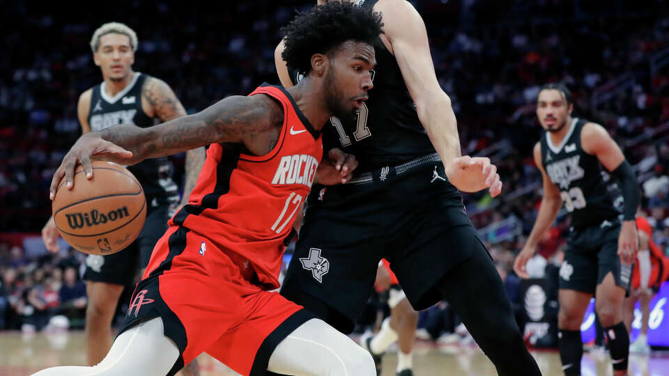 Houston Rockets forward Tari Eason, center left, drives into San Antonio Spurs forward Doug McDermott, center right, as Jeremy Sochan, left, and Tre Jones, right, look on during the second half of an NBA basketball game, Monday, Dec. 11, 2023, in Houston. (AP Photo/Michael Wyke)