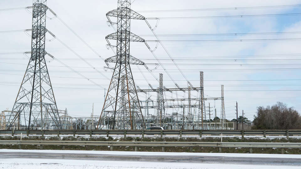 Power lines are shown near Beltway 8 the Hardy Toll Road following an overnight snowfall Monday, Feb. 15, 2021 in Houston.