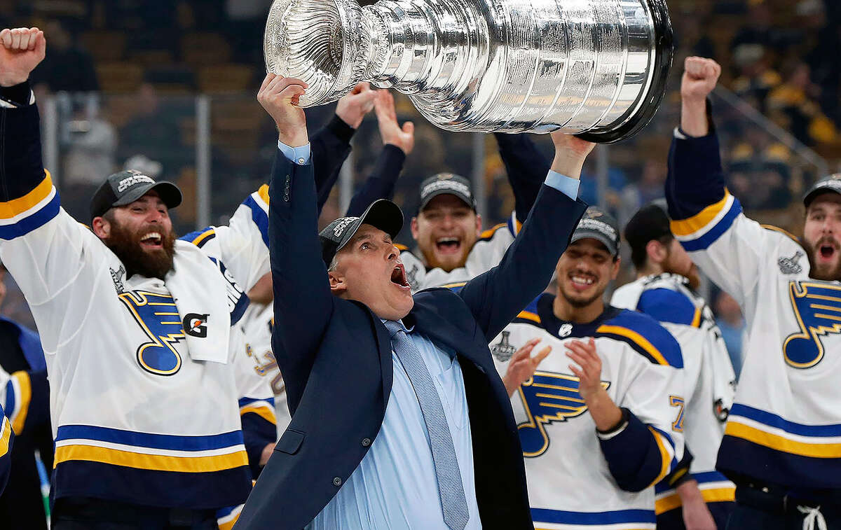 My dad drinking out of the Stanley cup with the Blues coach : r/hockey