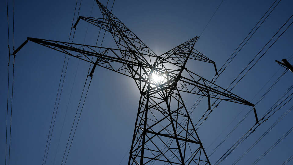 Long-distance transmission power lines cross through Plano, Texas near Spring Creek Parkway and the Dallas North Tollway, August 17, 2023.