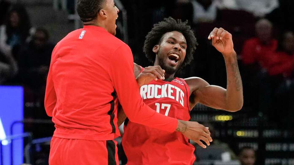 Houston Rockets forward Tari Eason, right, celebrates with forward Jabari Smith Jr. after getting a lob dunk from forward Jae'Sean Tate during the first half of an NBA basketball game at Toyota Center, Wednesday, Dec. 13, 2023, in Houston.