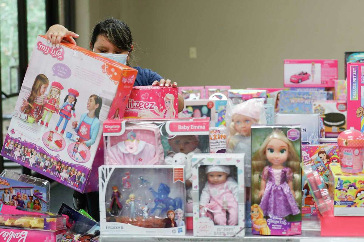 Norberta Rivas looks for Christmas gifts for her children at the South County Community Center, Friday, Dec. 17, 2021, in The Woodlands. More than 700 families received holiday gifts through the toy drive.