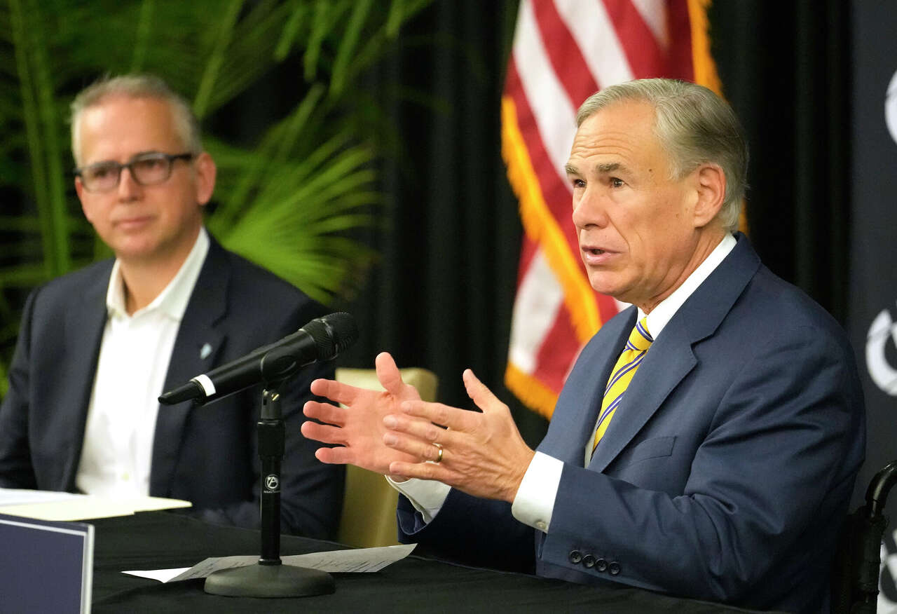 Pablo Vegas, president and CEO of ERCOT, left, and Texas Governor Greg Abbott, right, are shown during press conference at Calpine, 717 Texas Ave., Thursday, Dec. 14, 2023, in Houston.