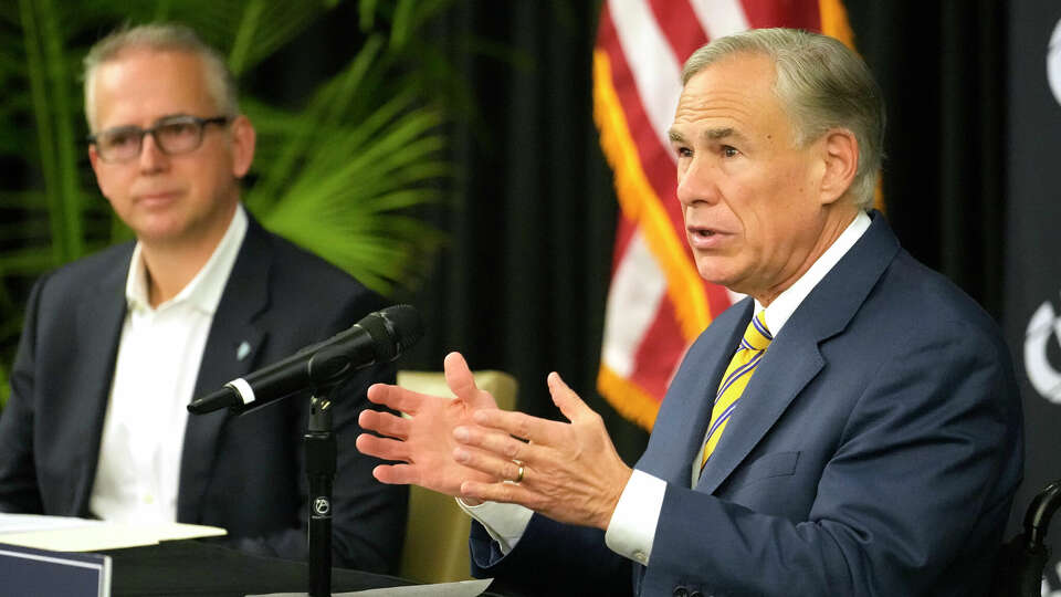 Pablo Vegas, president and CEO of ERCOT, left, and Texas Governor Greg Abbott, right, are shown during press conference at Calpine, 717 Texas Ave., Thursday, Dec. 14, 2023, in Houston.