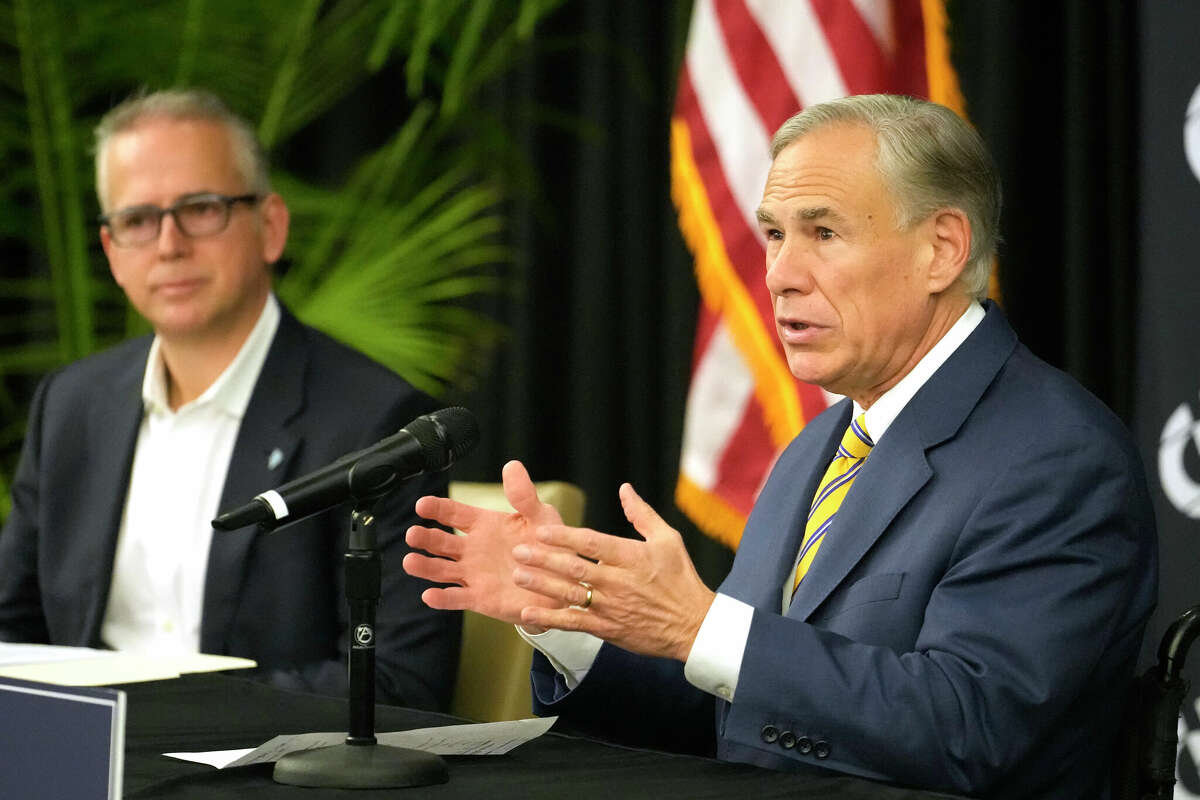 Pablo Vegas, president and CEO of ERCOT, left, and Texas Governor Greg Abbott, right, are shown during press conference at Calpine, 717 Texas Ave., Thursday, Dec. 14, 2023, in Houston.