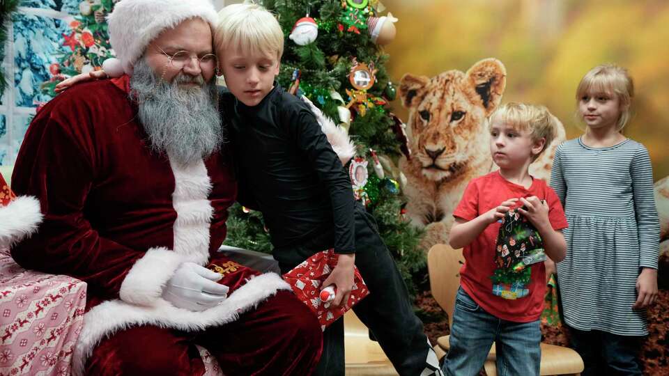 Korben Vaughan hugs Santa during the third annual 