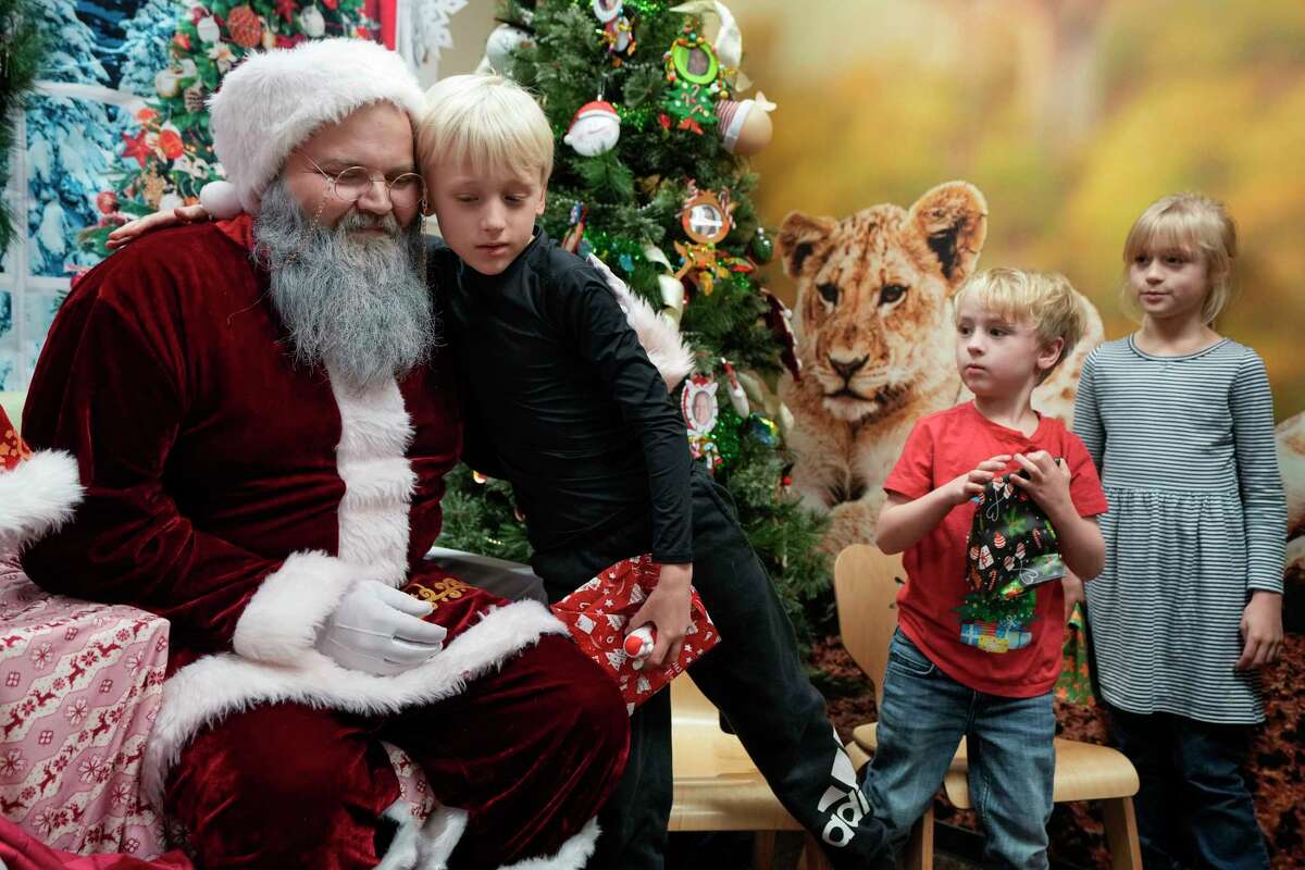 Korben Vaughan hugs Santa during the third annual 