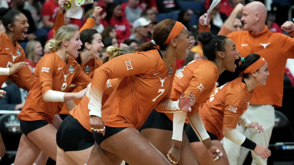 Texas players react after the team defeated Wisconsin during a semifinal match in the NCAA Division I women's college volleyball tournament Thursday, Dec. 14, 2023, in Tampa, Fla. (AP Photo/Chris O'Meara)