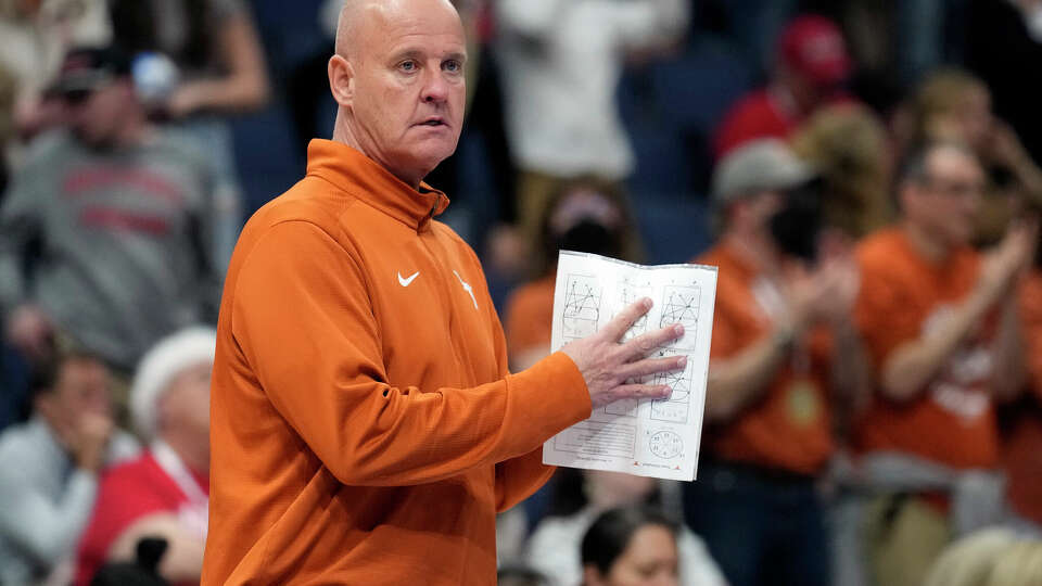 Texas head coach Jerritt Elliott calls a play against Wisconsin during a semifinal match in the NCAA Division I women's college volleyball tournament Thursday, Dec. 14, 2023, in Tampa, Fla. (AP Photo/Chris O'Meara)