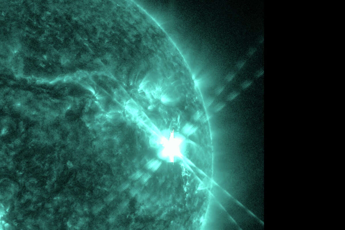 This photo provided by NASA's Solar Dynamics Observatory captured this image of a solar flare, as seen in the bright flash in the upper right, on Thursday, Dec. 14, 2023. The sun spit out the huge flare at noon on Thursday, resulting in two hours of radio interference in the U.S. and other sunlit parts of the world. (NASA via AP)