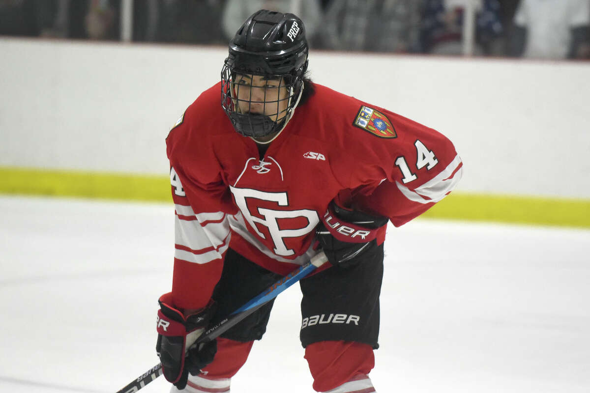Fairfield Prep's Christopher Sola (14) awaits a faceoff against New Canaan during a boys ice hockey game at the Darien Ice House on Friday, Dec. 15, 2023.