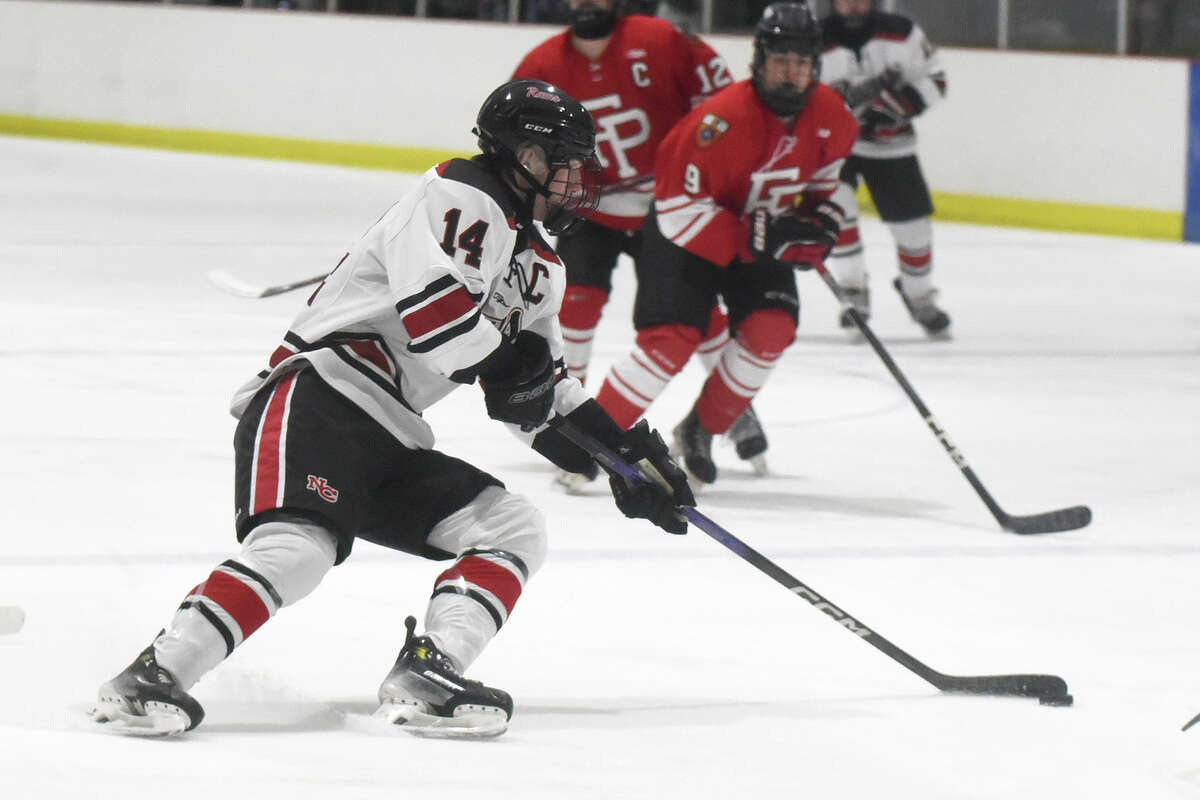 New Canaan's Gavin Fitzpatrick (14) looks for a shot against Fairfield Prep during a boys ice hockey game at the Darien Ice House on Friday, Dec. 15, 2023.