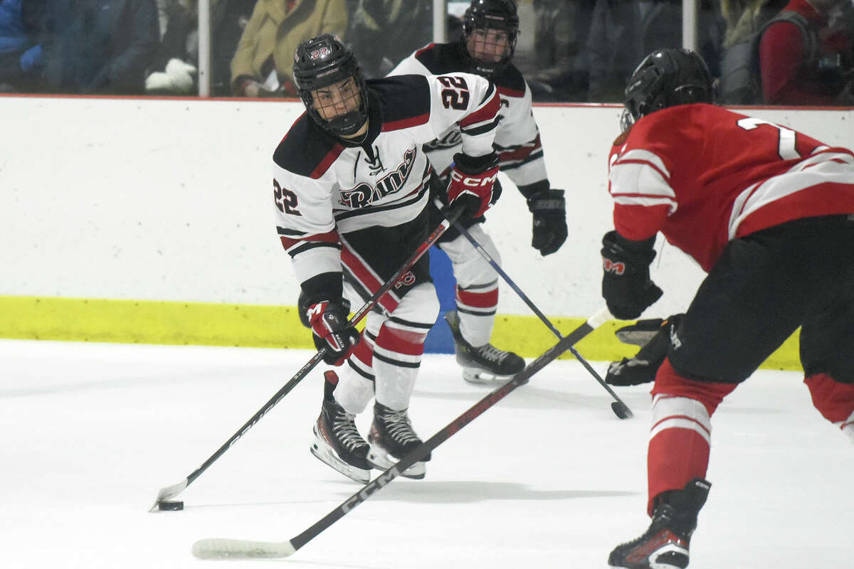 New Canaan's Elliott Kropf (22) lines up a shot against Fairfield Prep during a boys ice hockey game at the Darien Ice House on Friday, Dec. 15, 2023.