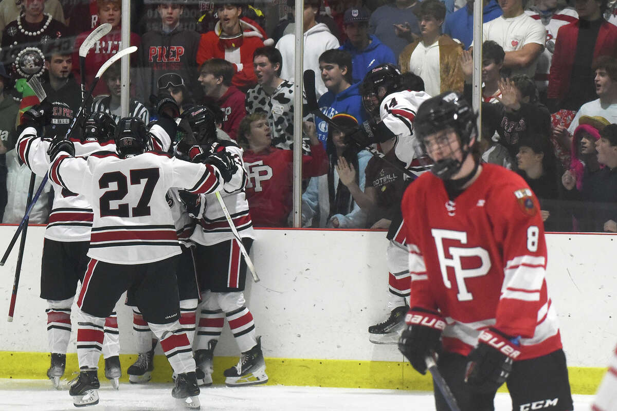 New Canaan players celebrate a goal in front of Fairfield Prep's fans during a boys ice hockey game at the Darien Ice House on Friday, Dec. 15, 2023.