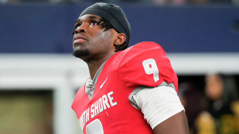 North Shore quarterback Kaleb Bailey (9) looks up at the video board showing Duncanville celebrating their 49-33 in the 6A Division I UIL state championship game at AT&T Stadium, Saturday, Dec. 16, 2023, in Arlington.