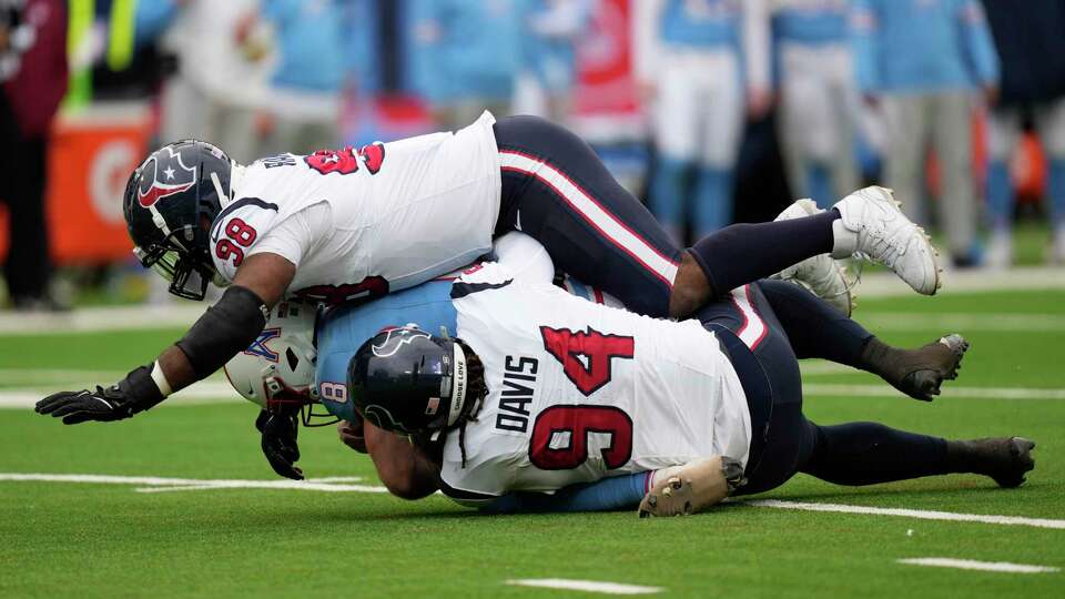 Houston Texans defensive tackles Sheldon Rankins (98) and Khalil Davis (94) sack Tennessee Titans quarterback Will Levis (8) during the first half of an NFL football game at Nissan Stadium, Sunday, Dec. 17, 2023, in Nashville, Tenn.