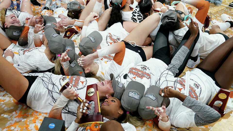 Texas players celebrate after defeating Nebraska during the championship match in the NCAA Division I women's college volleyball tournament Sunday, Dec. 17, 2023, in Tampa, Fla. (AP Photo/Chris O'Meara)
