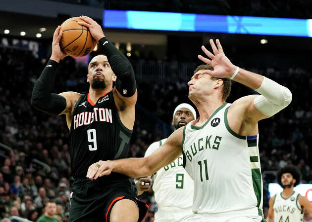 Houston Rockets' Dillon Brooks (9) looks to shoot against Milwaukee Bucks' Brook Lopez (11) during the first half of an NBA basketball game Sunday, Dec. 17, 2023, in Milwaukee. (AP Photo/Aaron Gash)