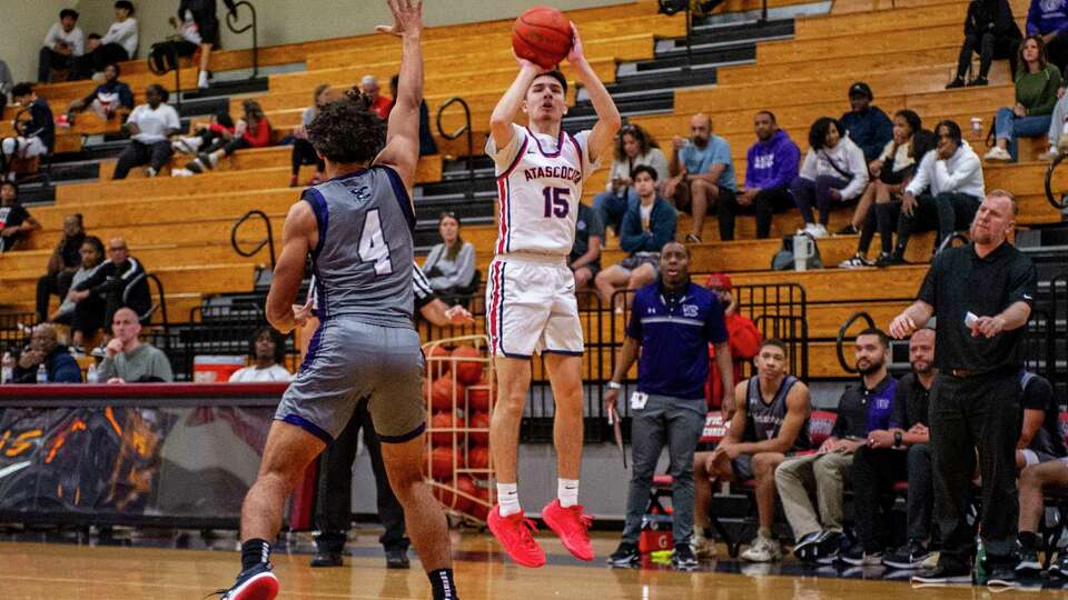 Atascocita's Luke Martinez (15) puts up a shot over Klein Cain's Maxwell Hendricks (4) in the first half of a boys high school basketball game Tuesday, Dec. 19, 2023 at Atascocita High School.