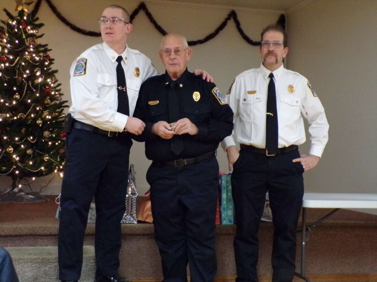 Michigan State Fire Marshal awards 50-year service coin to Marvin Bell