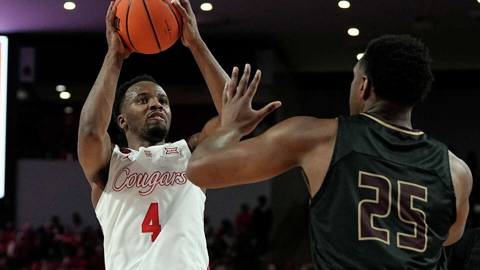 Houston guard L.J. Cryer (4) shoots over Texas State forward Chris Nix (25) during the second half of an NCAA college basketball game, Thursday, Dec. 21, 2023, in Houston. (AP Photo/Kevin M. Cox)